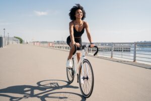 Happy,Smiling,Young,Woman,Curly-haired,Contented,Activity,Road,Bike,Riding