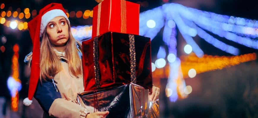 Tired,Christmas,Woman,Holding,A,Big,Pile,Of,Gift,Boxes.