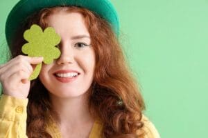 Young,Redhead,Woman,With,Paper,Clover,On,Green,Background.,St.